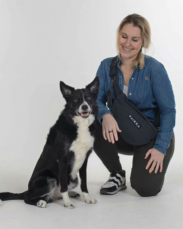 Dog with owner carrying Paikka Treat Bag